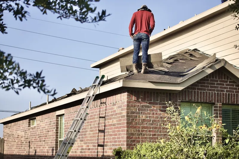Professional roofer working on a residential roof in Hillsdale Heights